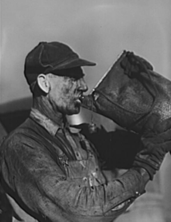 Carbon Black Worker Drinks from Canvas Bag in 1942
