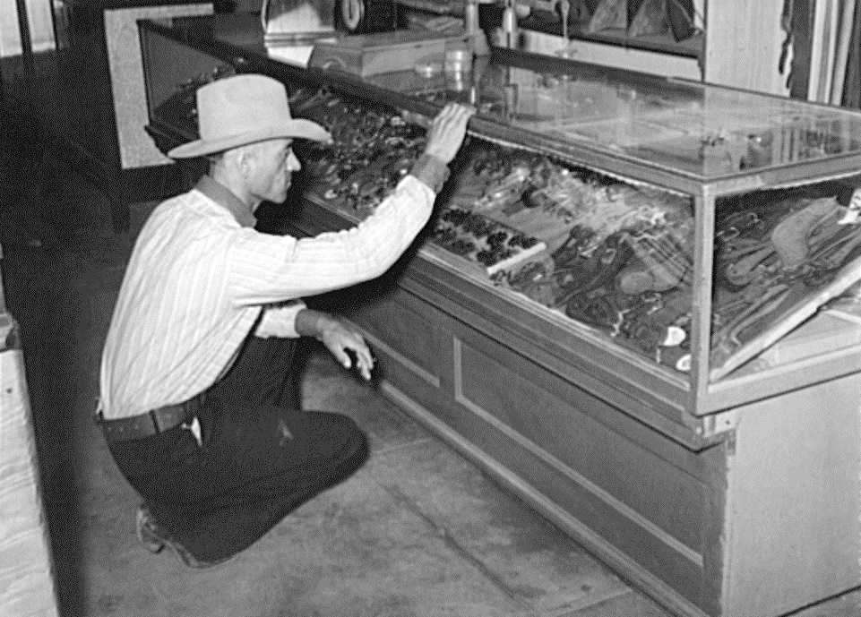 Cowboy Looks at Spurs Display in 1939
