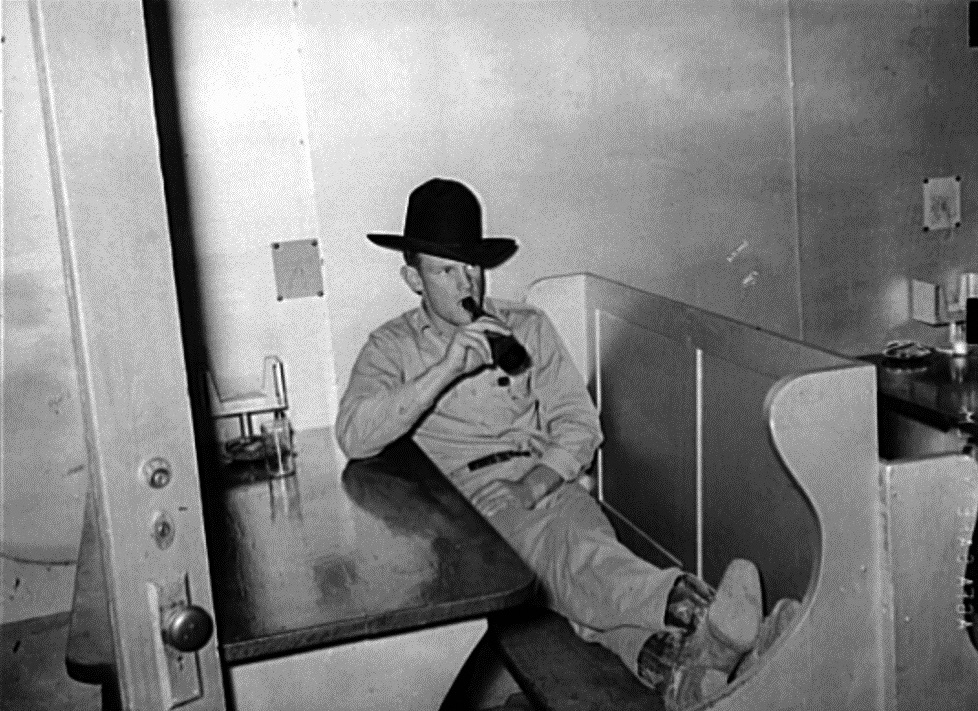 Cowboy Relaxes in Cafe Booth in 1939