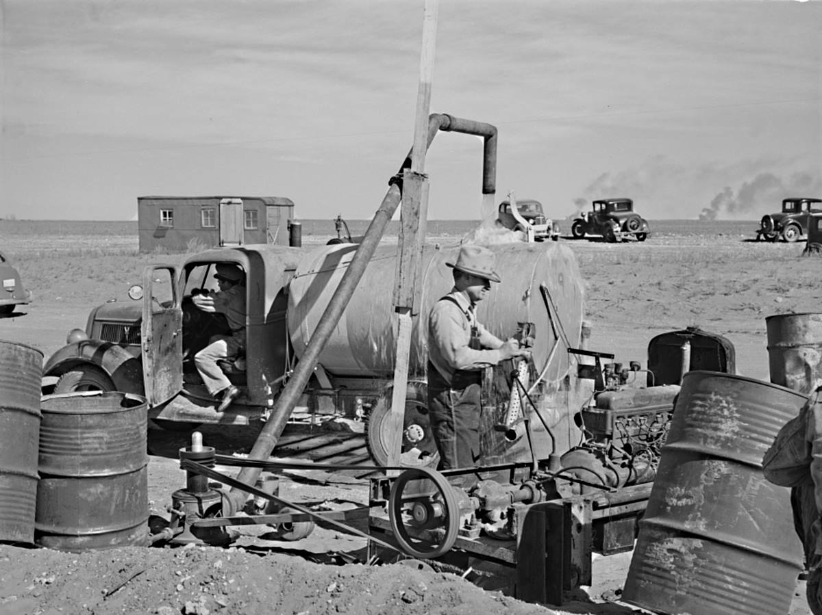 Filling Tank w Water from Irrigation Well in 1940