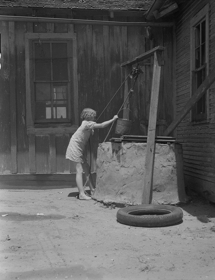 Girl Drawing Water from Well In Hall County Texas in 1939